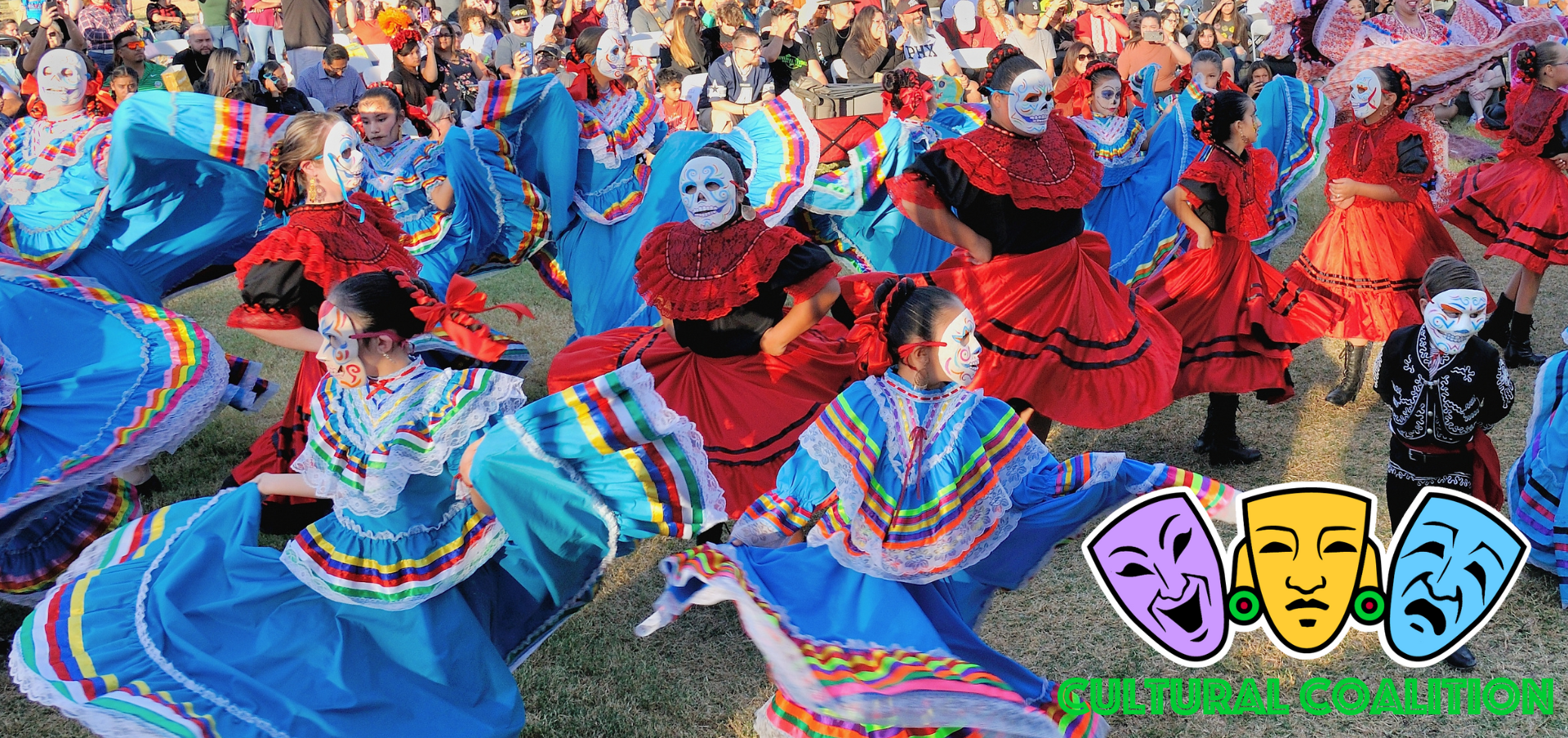 Youth folklorico dancers in colorful dresses wearing calaca (skeleton) masks created by Zarco Guerrero